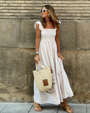 Women’s evening dress with ruffle accents and checkered sleeves