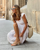Women’s evening dress with ruffle accents and checkered sleeves