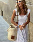 Women’s evening dress with ruffle accents and checkered sleeves