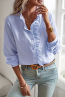 Women's blouse with ruffle accents and clean button front