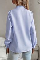 Women's blouse with ruffle accents and clean button front