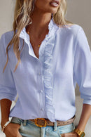 Women's blouse with ruffle accents and clean button front